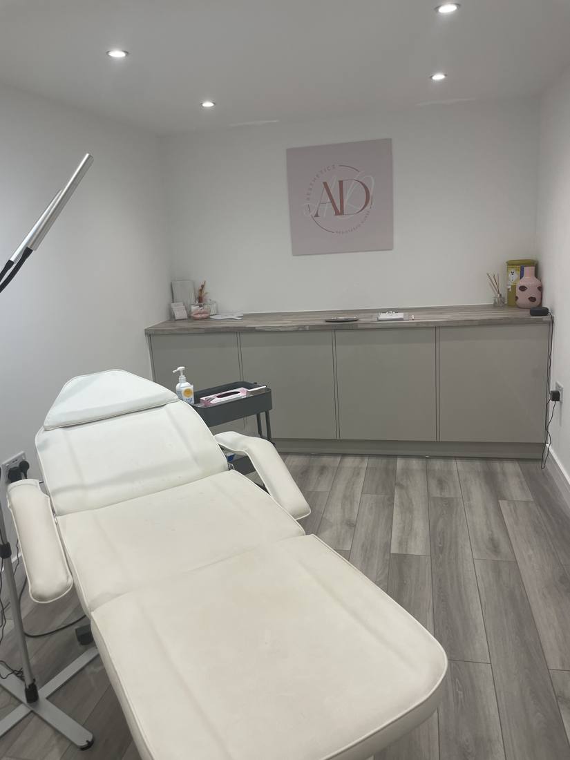 Treatment chair beneath the AD Aesthetics logo